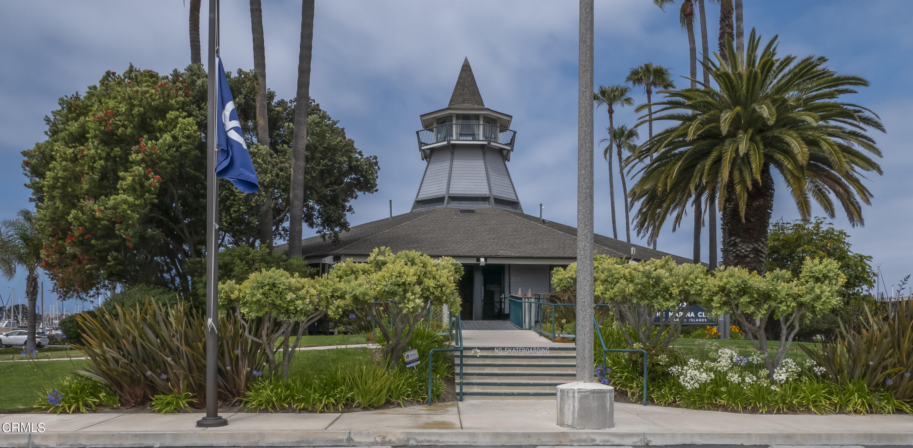 3101 Peninsula Road, Unit 307 Oxnard, CA 93035 - Photo 14 of 22 a front view of a house with a yard and potted plants