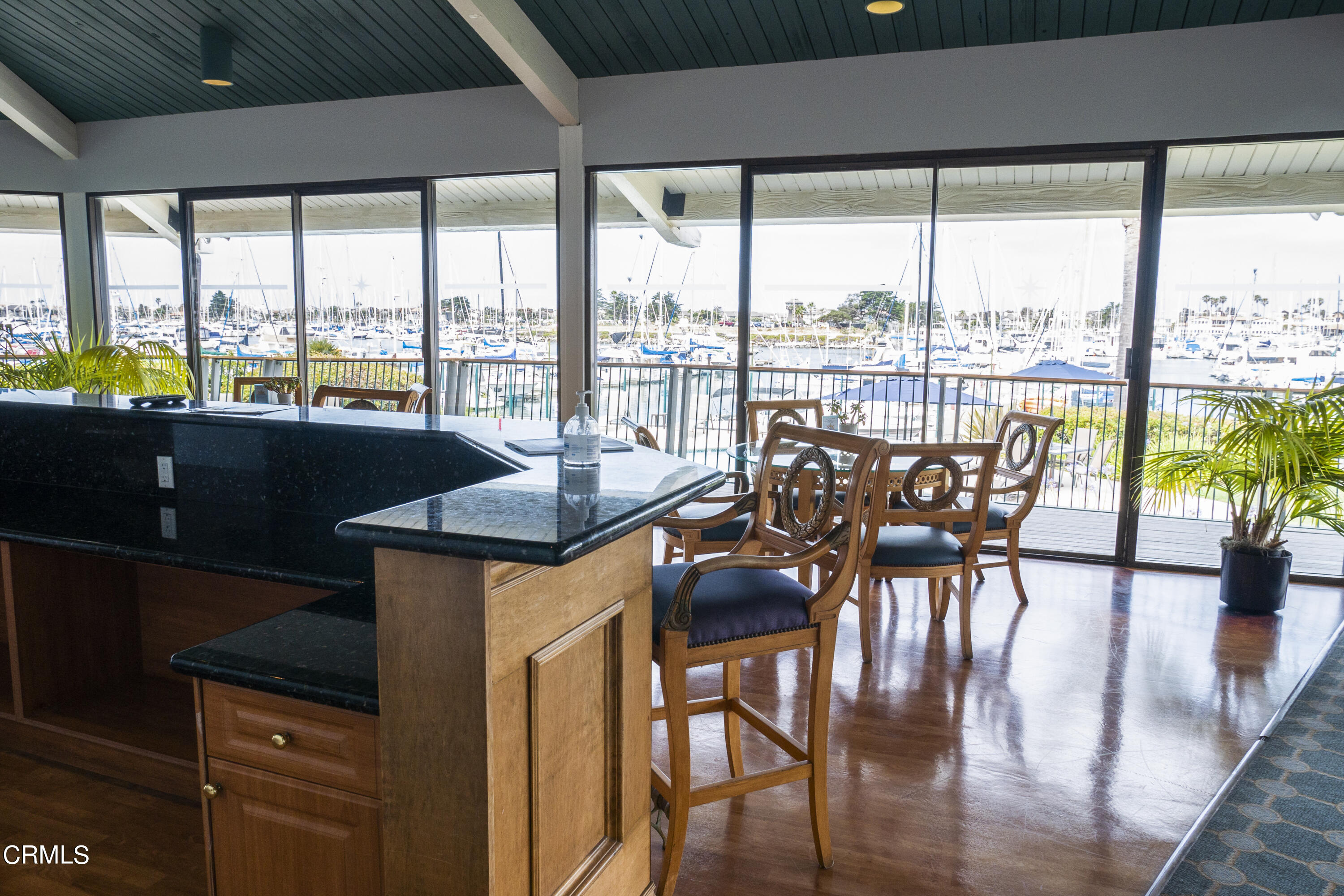 3101 Peninsula Road, Unit 307 Oxnard, CA 93035 - Photo 19 of 22 a view of a dining room with furniture window and wooden floor