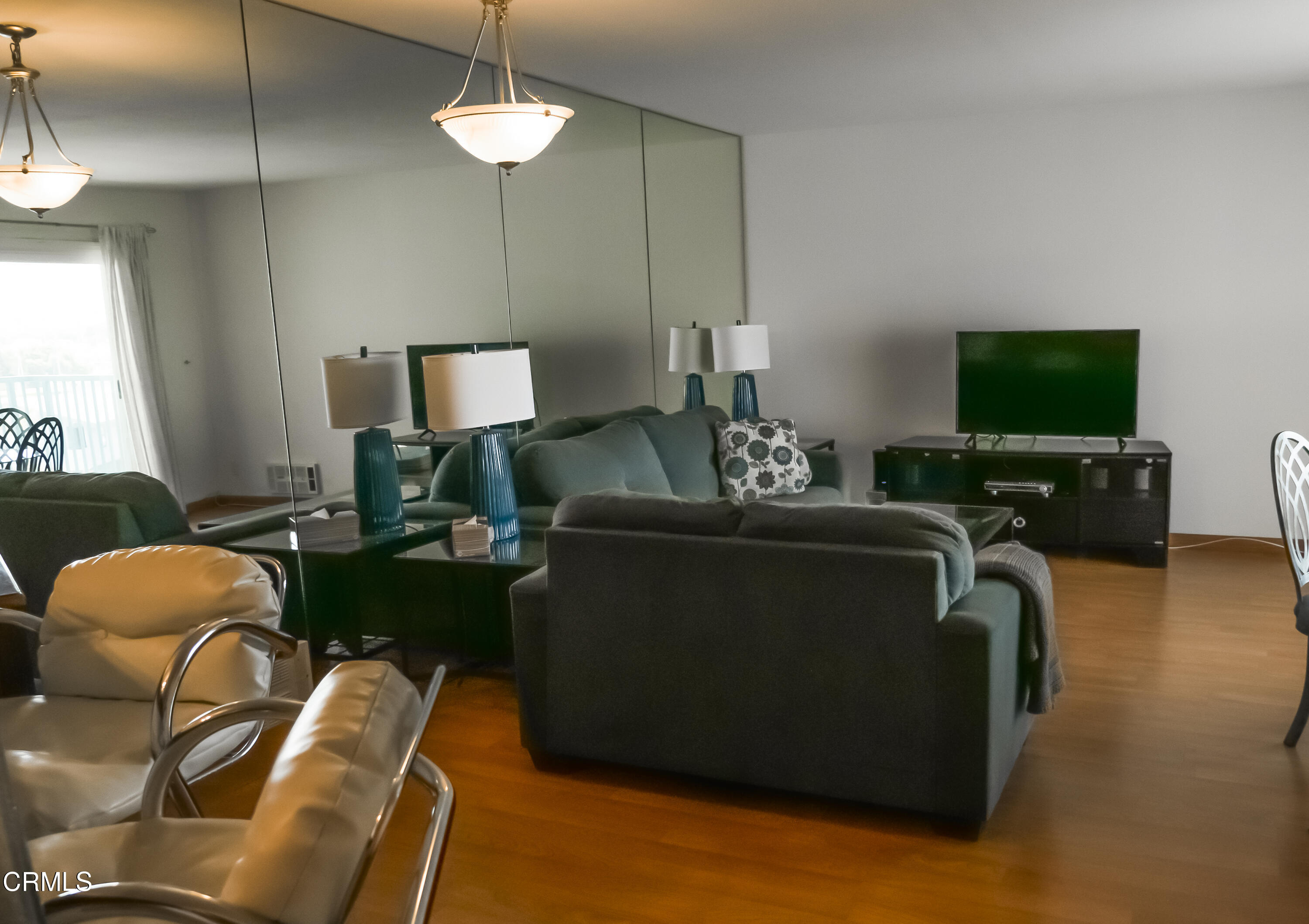 3101 Peninsula Road, Unit 307 Oxnard, CA 93035 - Photo 2 of 22 a living room with furniture and a flat screen tv