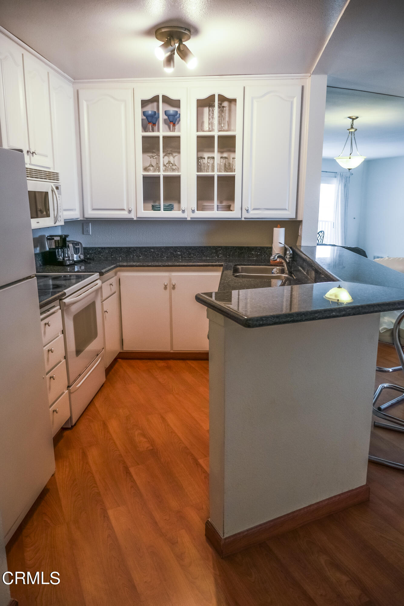 3101 Peninsula Road, Unit 307 Oxnard, CA 93035 - Photo 9 of 22 a kitchen with stainless steel appliances granite countertop a sink and a stove