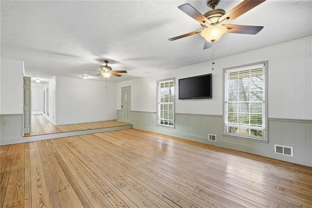 a kitchen with granite countertop stainless steel appliances a sink a counter top space cabinets and stainless steel appliances