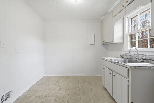 a kitchen that has a lot of cabinets and appliances