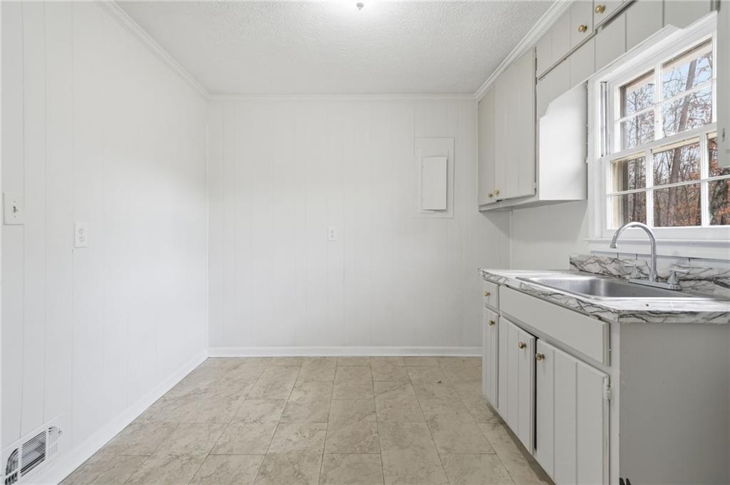 253 Newt Fowler Lane Canton, GA 30115 - Photo 23 of 35 a kitchen with a sink and cabinets