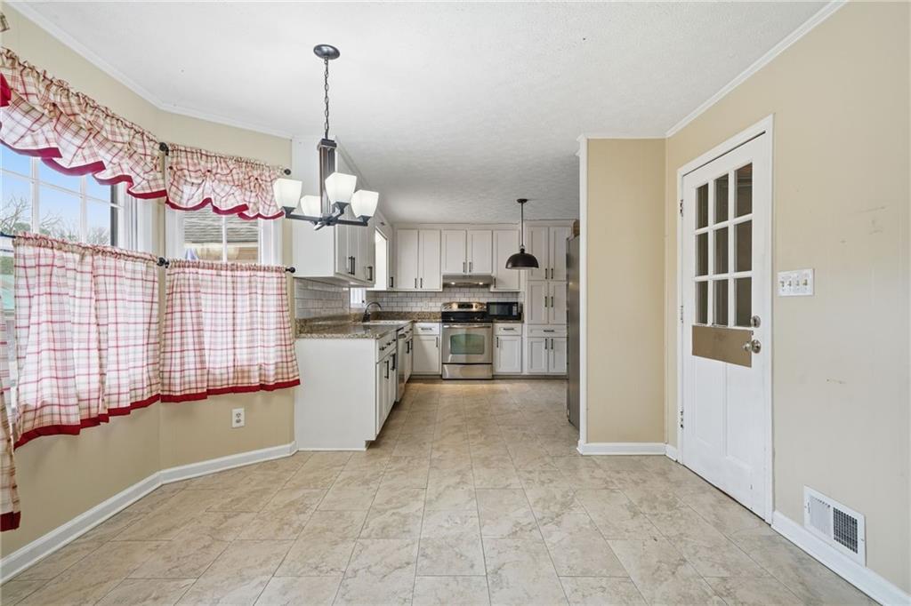 253 Newt Fowler Lane Canton, GA 30115 - Photo 24 of 35 a kitchen that has a lot of cabinets and appliances