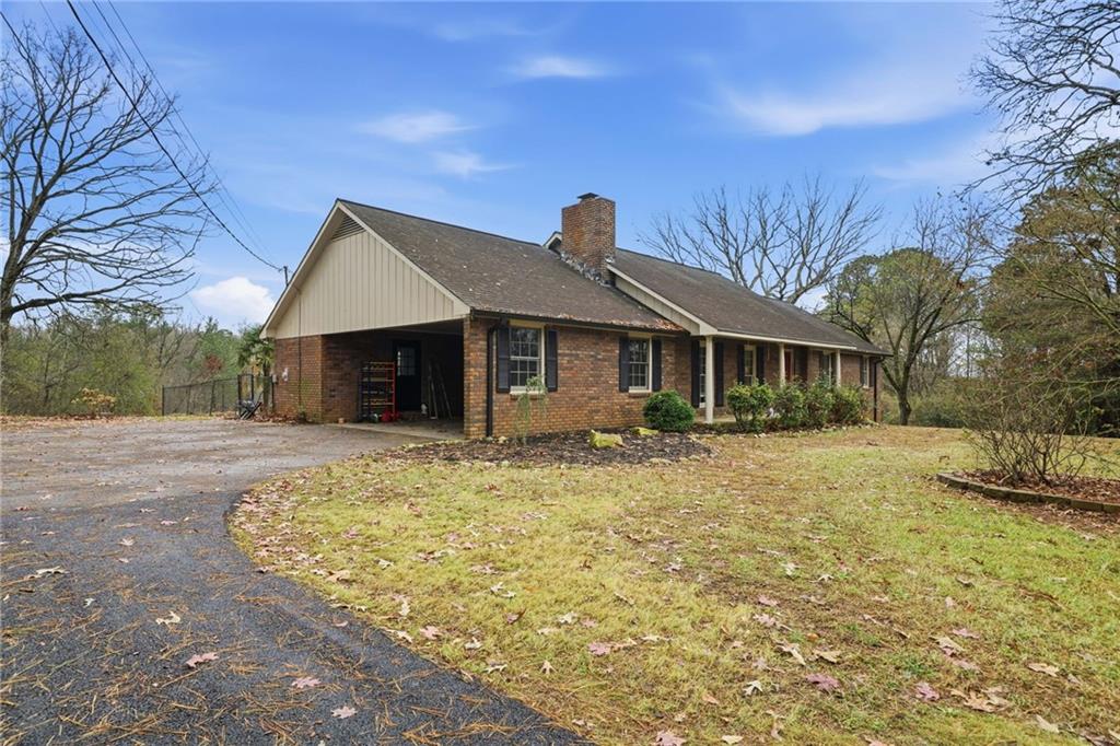 253 Newt Fowler Lane Canton, GA 30115 - Photo 3 of 35 a front view of a house with a yard and garage