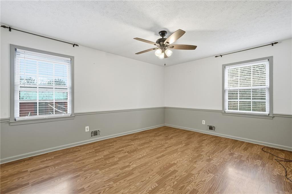253 Newt Fowler Lane Canton, GA 30115 - Photo 31 of 35 a view of empty room with wooden floor and fan