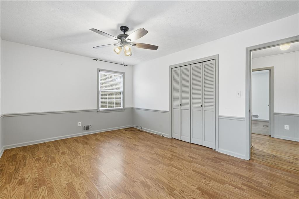 253 Newt Fowler Lane Canton, GA 30115 - Photo 32 of 35 wooden floor in an empty room with a window