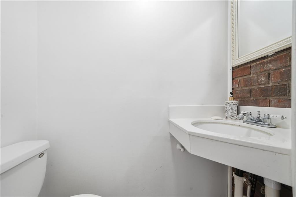 253 Newt Fowler Lane Canton, GA 30115 - Photo 35 of 35 a bathroom with a sink a toilet and a mirror