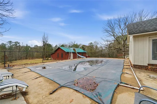 a backyard of a house with a yard and outdoor seating