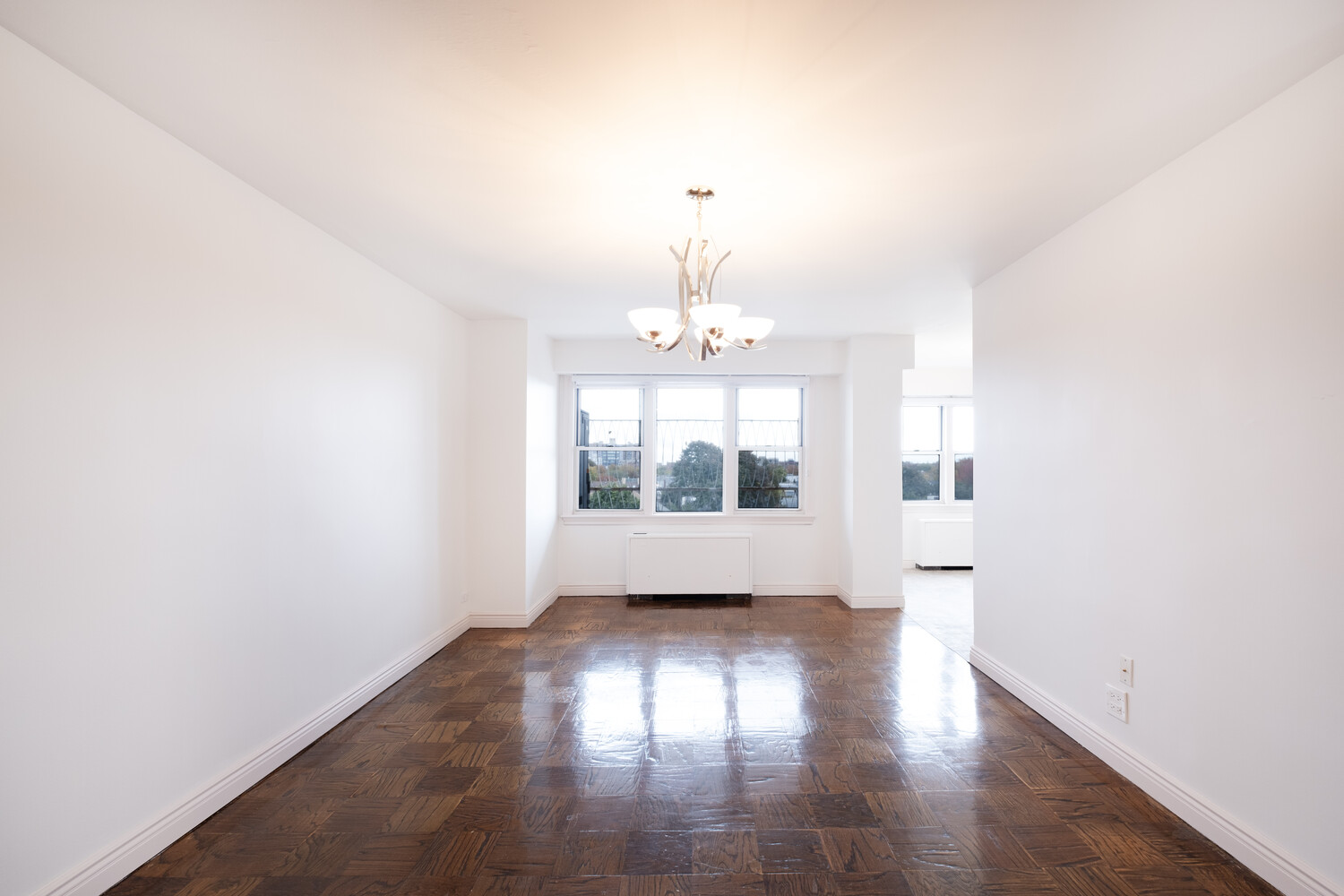 1401 Ocean Avenue, Unit 6H Brooklyn, NY 11230 - Photo 2 of 10 an empty room with wooden floor and windows