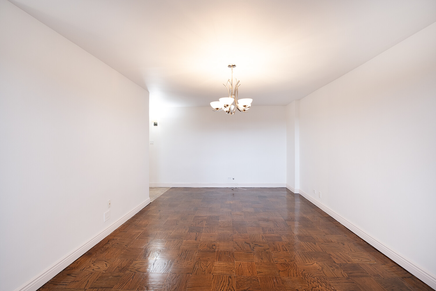 1401 Ocean Avenue, Unit 6H Brooklyn, NY 11230 - Photo 3 of 10 an empty room with a chandelier fan