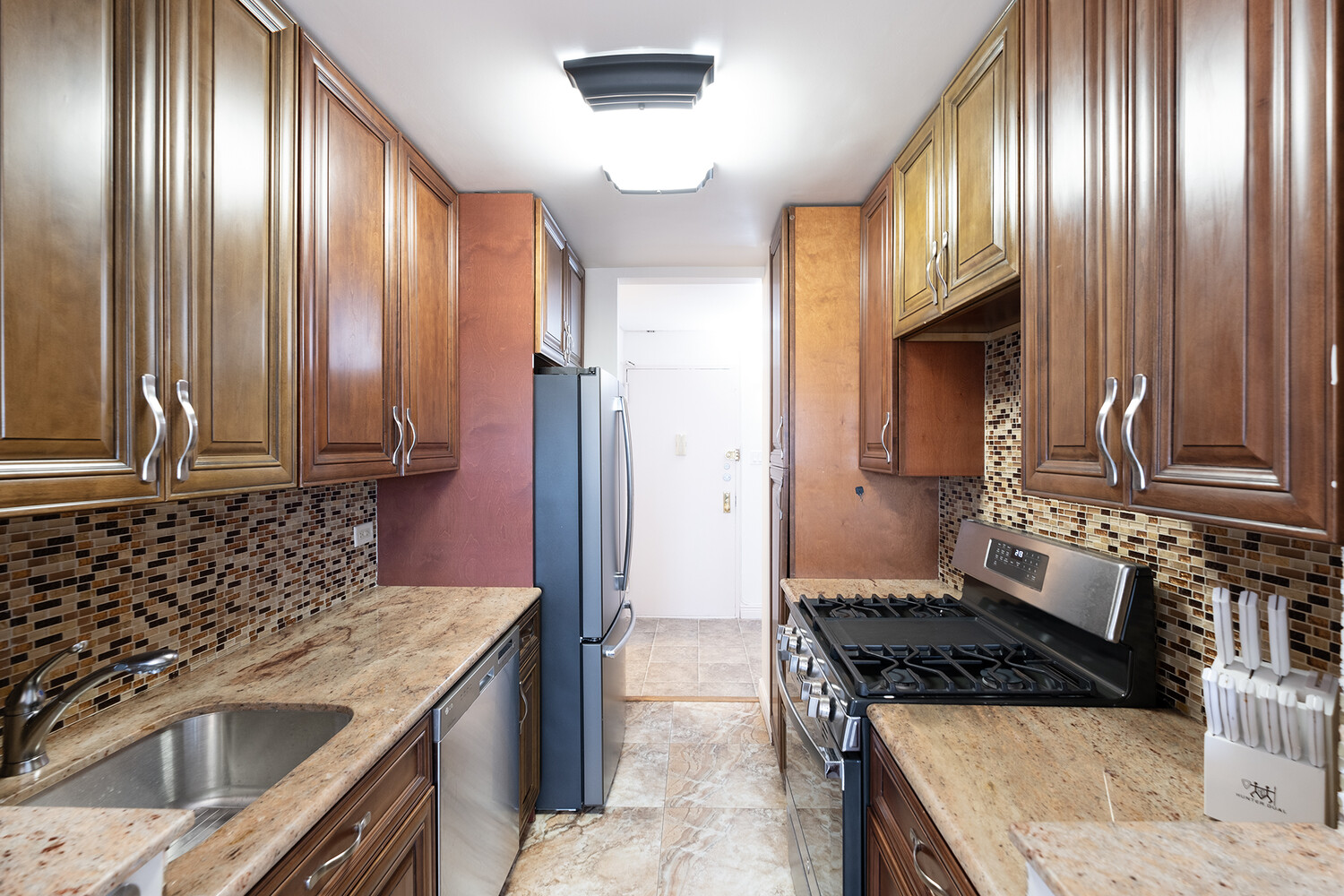 1401 Ocean Avenue, Unit 6H Brooklyn, NY 11230 - Photo 4 of 10 a kitchen with granite countertop stainless steel appliances a stove sink and cabinets