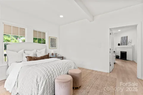 a bedroom with a bed and a fireplace