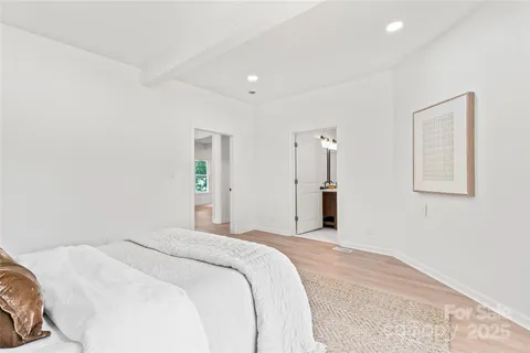 a bedroom with a bed and a painting on the wall