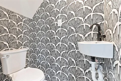 a bathroom with a toilet sink and mirror