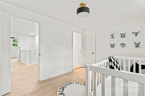 a view of a bedroom with baby crib