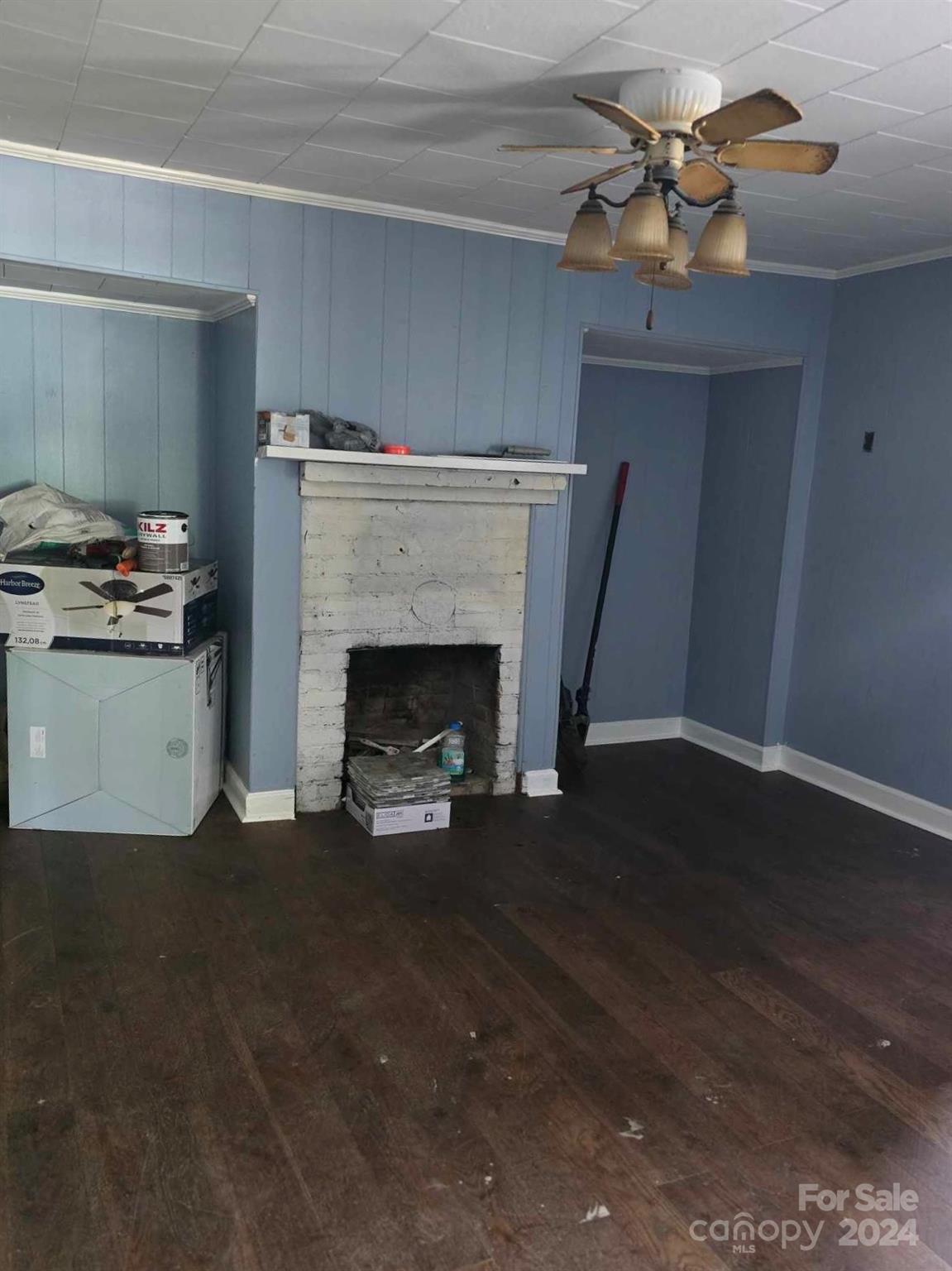 4080 Piney Road Morganton, NC 28655 - Photo 10 of 23 a view of a livingroom with a fireplace and a fan