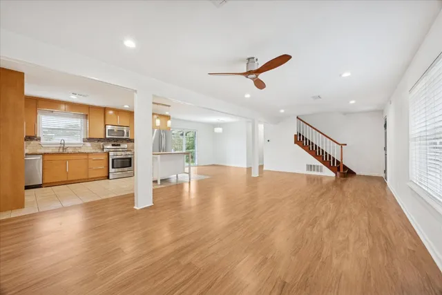 a view of a kitchen with a sink wooden floor and a kitchen