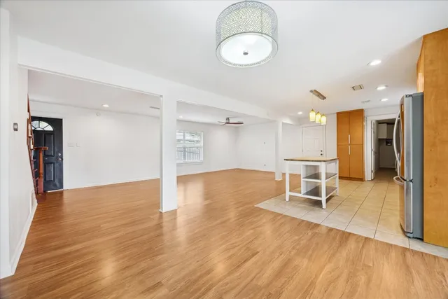 a view of a room with wooden floor table and chairs