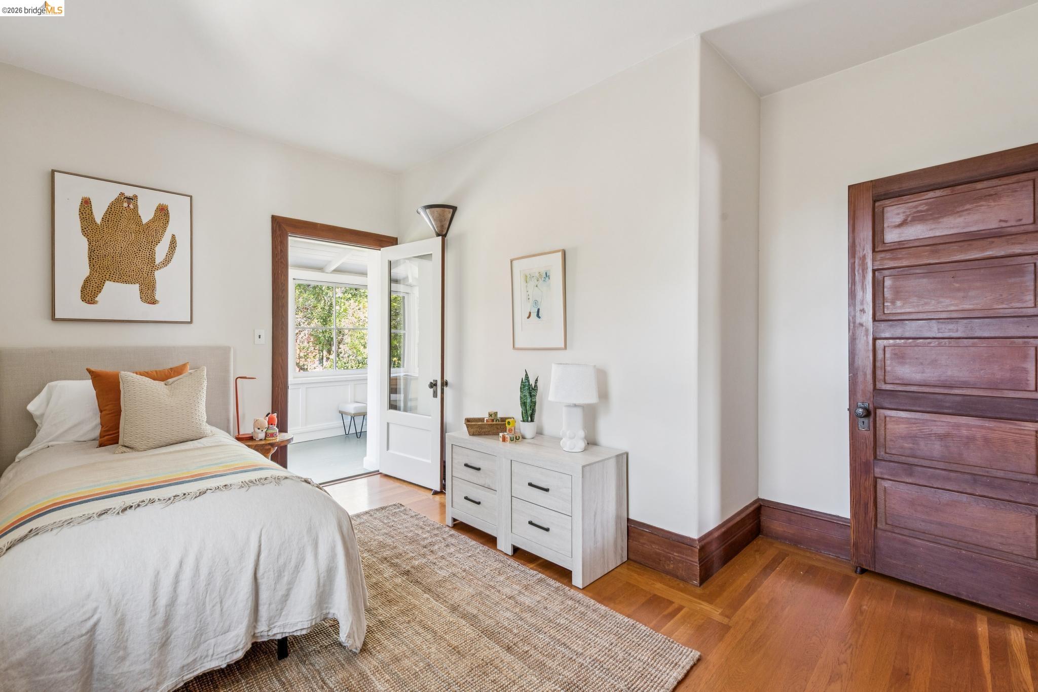 1490 Arch Street Berkeley, CA 94708 - Photo 36 of 57 a bedroom with a bed and wooden floor