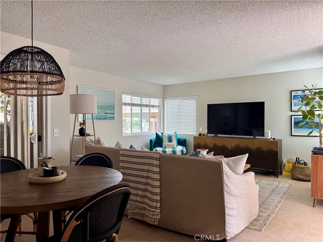 a living room with furniture a window and a flat screen tv