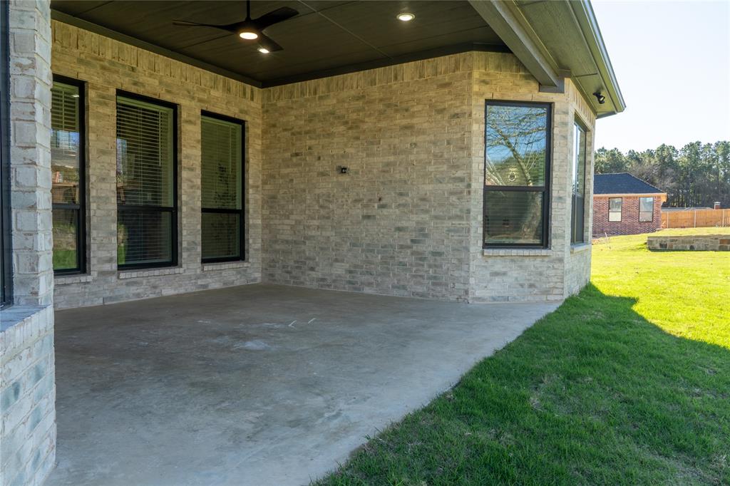 904 Tannehill Way Athens, TX 75751 - Photo 15 of 18 a view of a patio with table and chairs near a garden