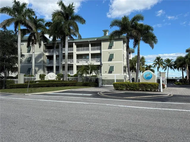 a front view of a building with palm trees