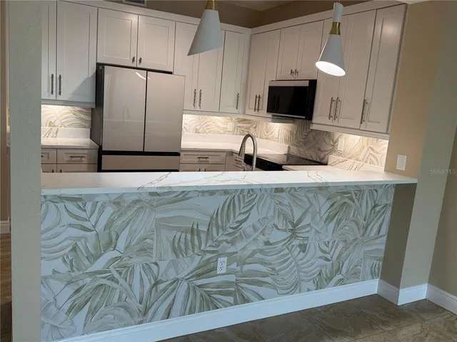 a kitchen with a stove and a refrigerator