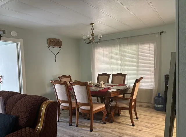 a view of a dining room with furniture and window