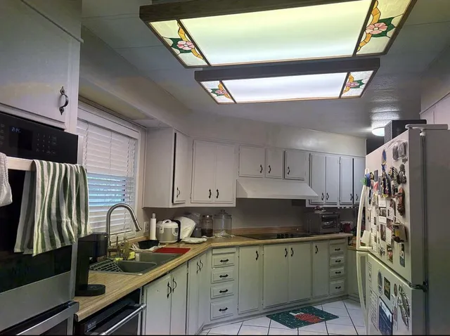 a kitchen with stainless steel appliances granite countertop a sink stove and cabinets