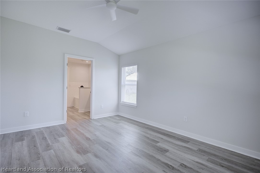 111 Vale Court Sebring, FL 33876 - Photo 18 of 40 wooden floor in an empty room