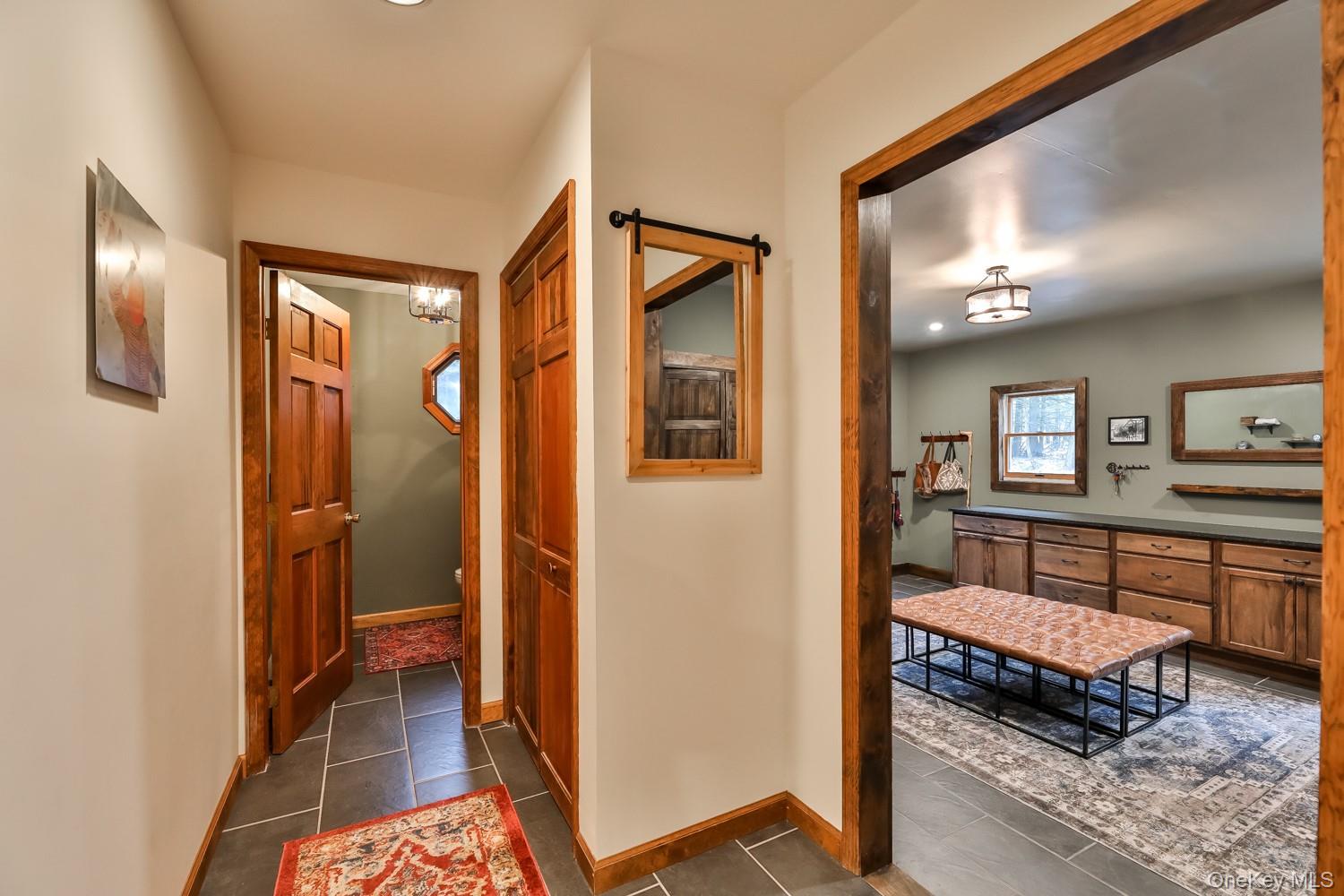 61 Mt View Estates Road Windham, NY 12496 - Photo 18 of 38 Hallway featuring dark tile patterned flooring and a chandelier
