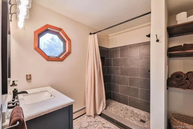 a bathroom with a bathtub a shower and a sink