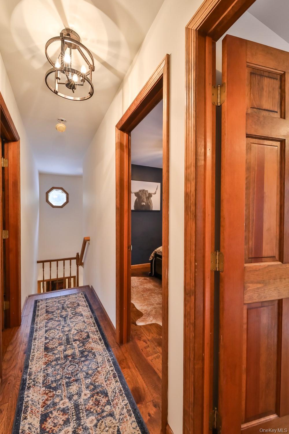 61 Mt View Estates Road Windham, NY 12496 - Photo 30 of 38 Hallway featuring hardwood / wood-style flooring and a chandelier