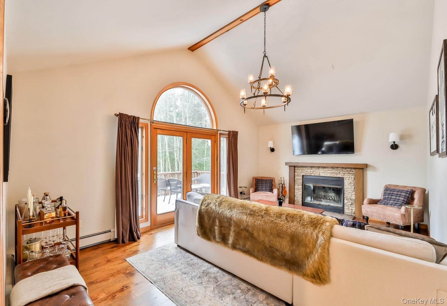 61 Mt View Estates Road Windham, NY 12496 - Photo 3 of 38 a living room with furniture a fireplace and a chandelier