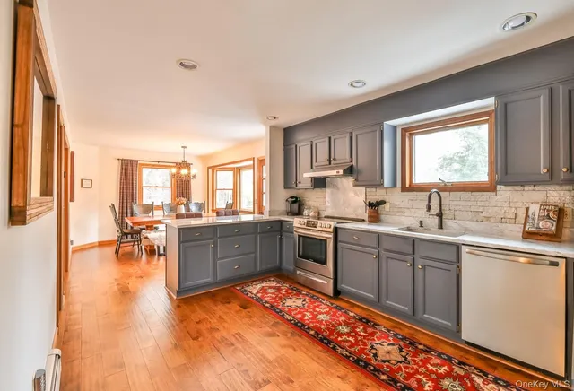a large kitchen with kitchen island a sink stainless steel appliances and cabinets