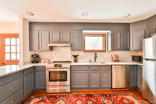 a kitchen with a sink stove and cabinets