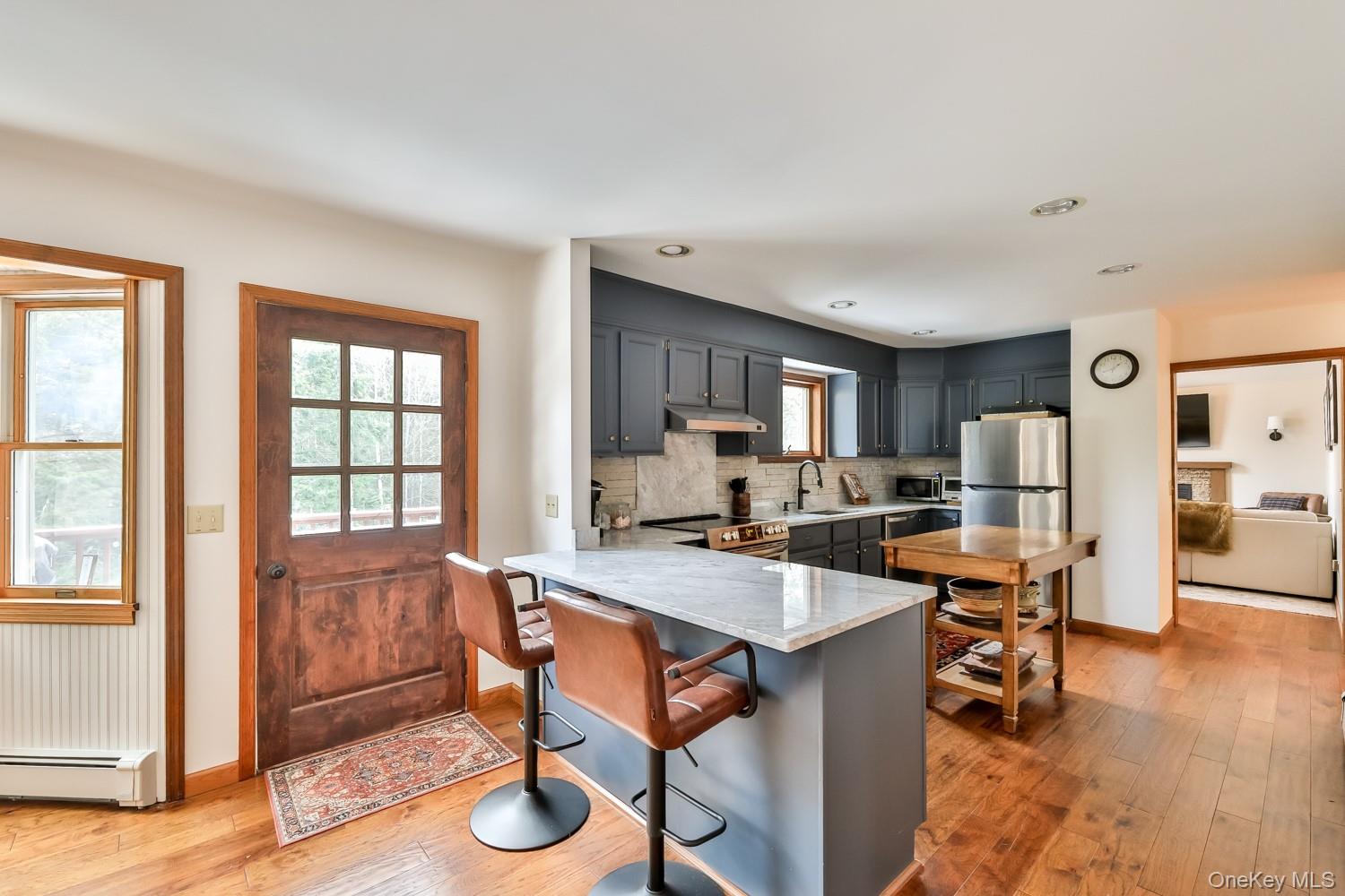 61 Mt View Estates Road Windham, NY 12496 - Photo 8 of 38 Kitchen with a peninsula, a breakfast bar area, gray cabinetry, healthy amount of natural light, and recessed lighting