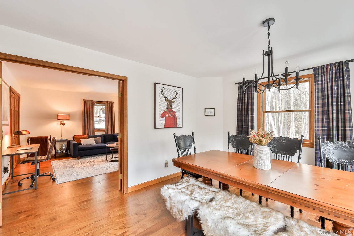61 Mt View Estates Road Windham, NY 12496 - Photo 10 of 38 a view of a dining room and livingroom with furniture wooden floor a chandelier
