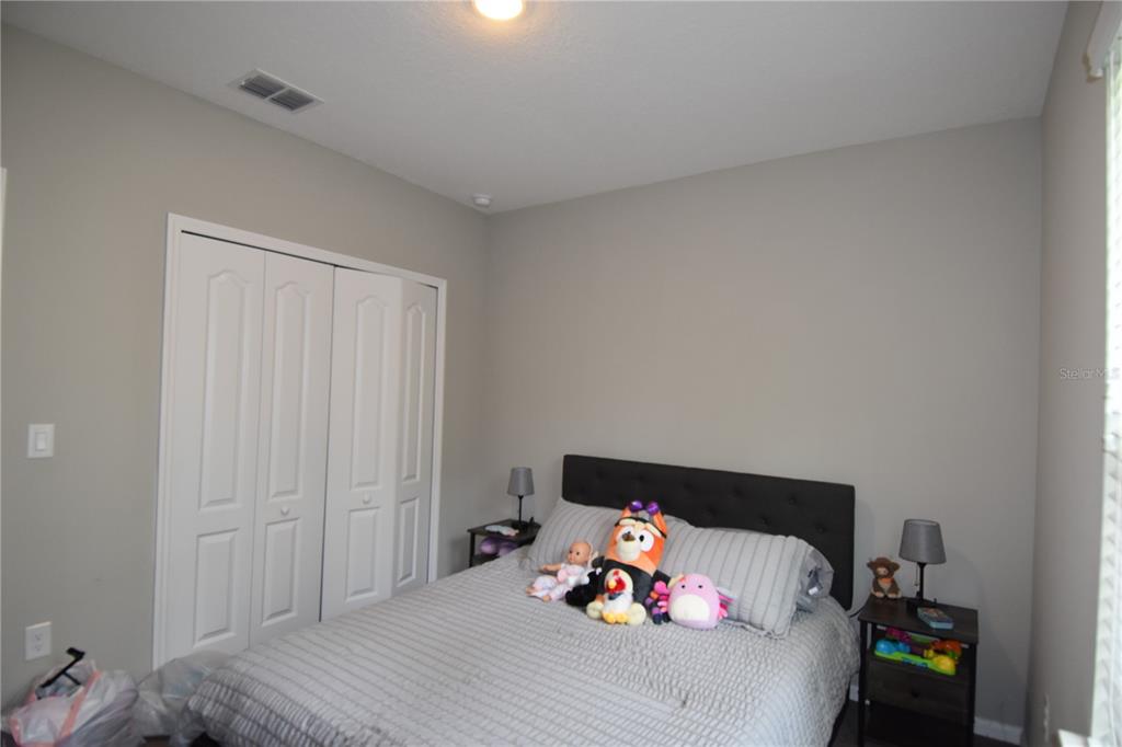 14241 Ravine Avenue Weeki Wachee, FL 34614 - Photo 13 of 48 a bedroom with a bed and closet