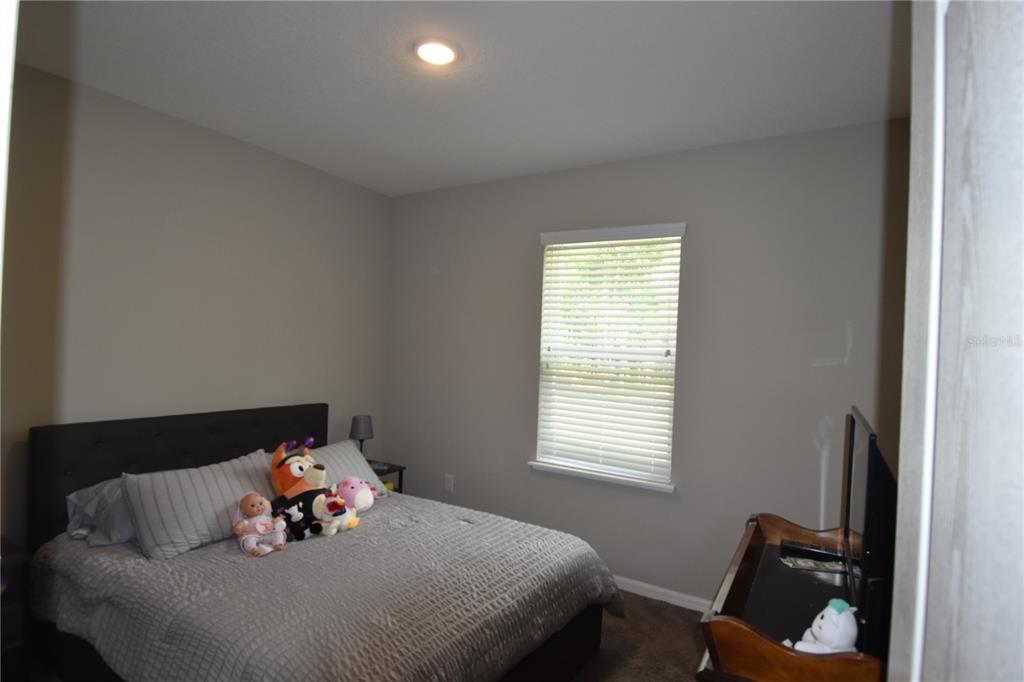 14241 Ravine Avenue Weeki Wachee, FL 34614 - Photo 14 of 48 a bedroom with a bed and window