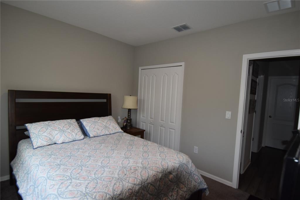 14241 Ravine Avenue Weeki Wachee, FL 34614 - Photo 16 of 48 a bedroom with a bed and a night stand