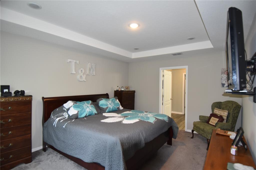 14241 Ravine Avenue Weeki Wachee, FL 34614 - Photo 17 of 48 a bedroom with a bed and flat screen tv