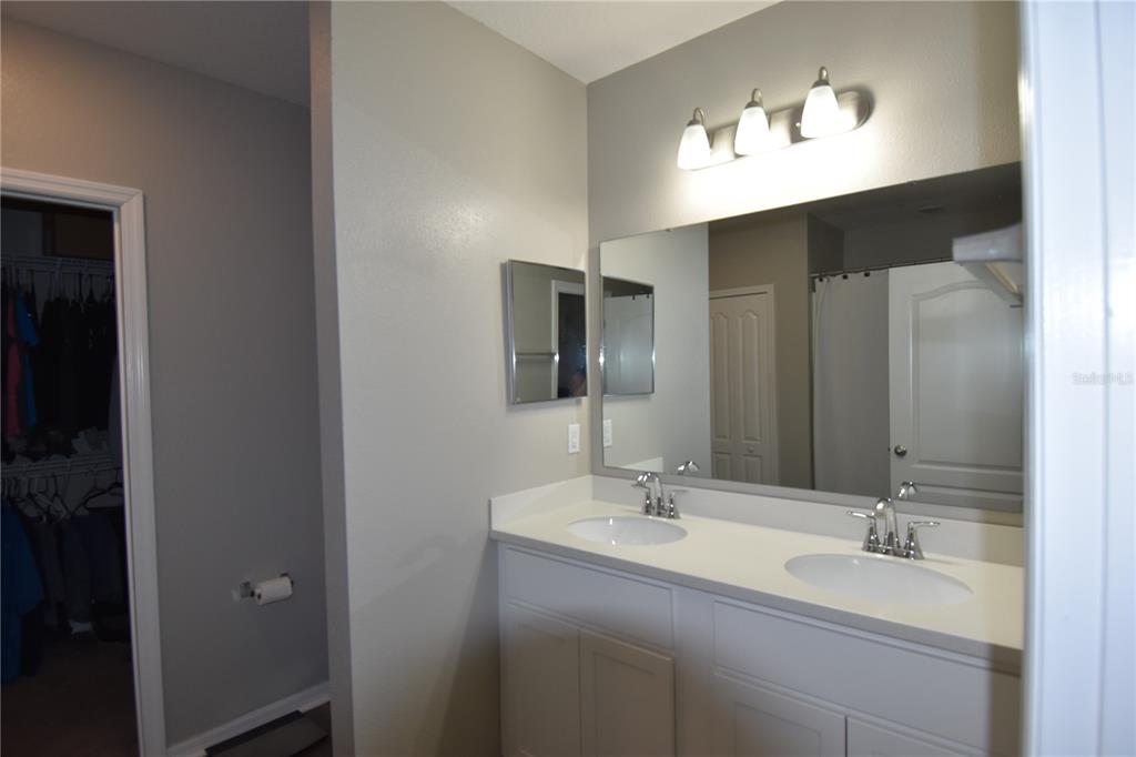 14241 Ravine Avenue Weeki Wachee, FL 34614 - Photo 20 of 48 a bathroom with a double vanity sink and a mirror