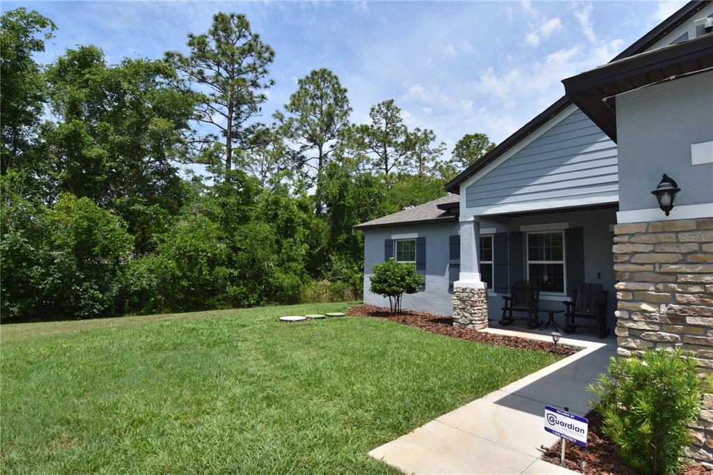 14241 Ravine Avenue Weeki Wachee, FL 34614 - Photo 2 of 48 a front view of house with yard and green space