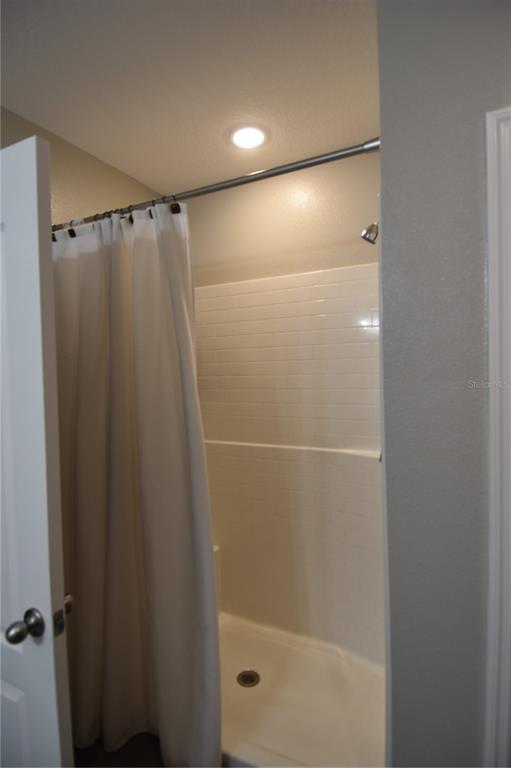 14241 Ravine Avenue Weeki Wachee, FL 34614 - Photo 22 of 48 a bathroom with a glass shower door