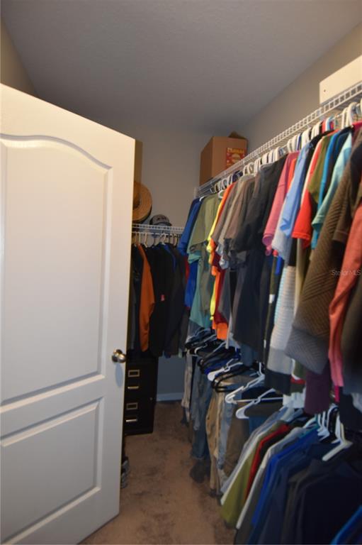 14241 Ravine Avenue Weeki Wachee, FL 34614 - Photo 23 of 48 a view of walk in closet with clothes and shoes