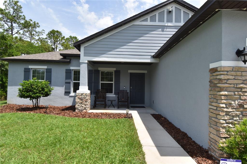 14241 Ravine Avenue Weeki Wachee, FL 34614 - Photo 3 of 48 a view of a house with backyard porch and sitting area
