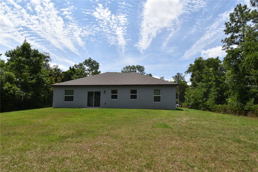 14241 Ravine Avenue Weeki Wachee, FL 34614 - Photo 31 of 48 a view of a house with a yard