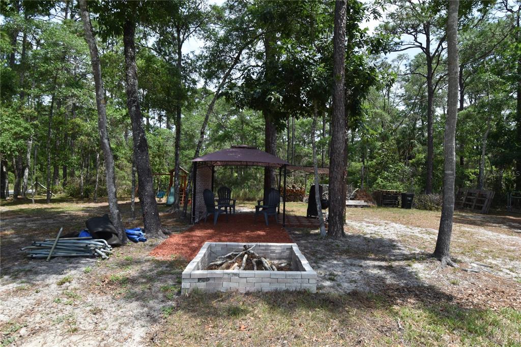 14241 Ravine Avenue Weeki Wachee, FL 34614 - Photo 34 of 48 a view of a yard with patio